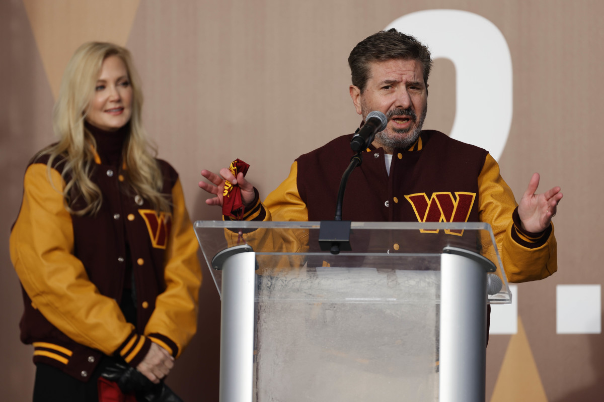 Washington Commanders co-owner Dan Snyder speaks as co-owner Tanya Snyder